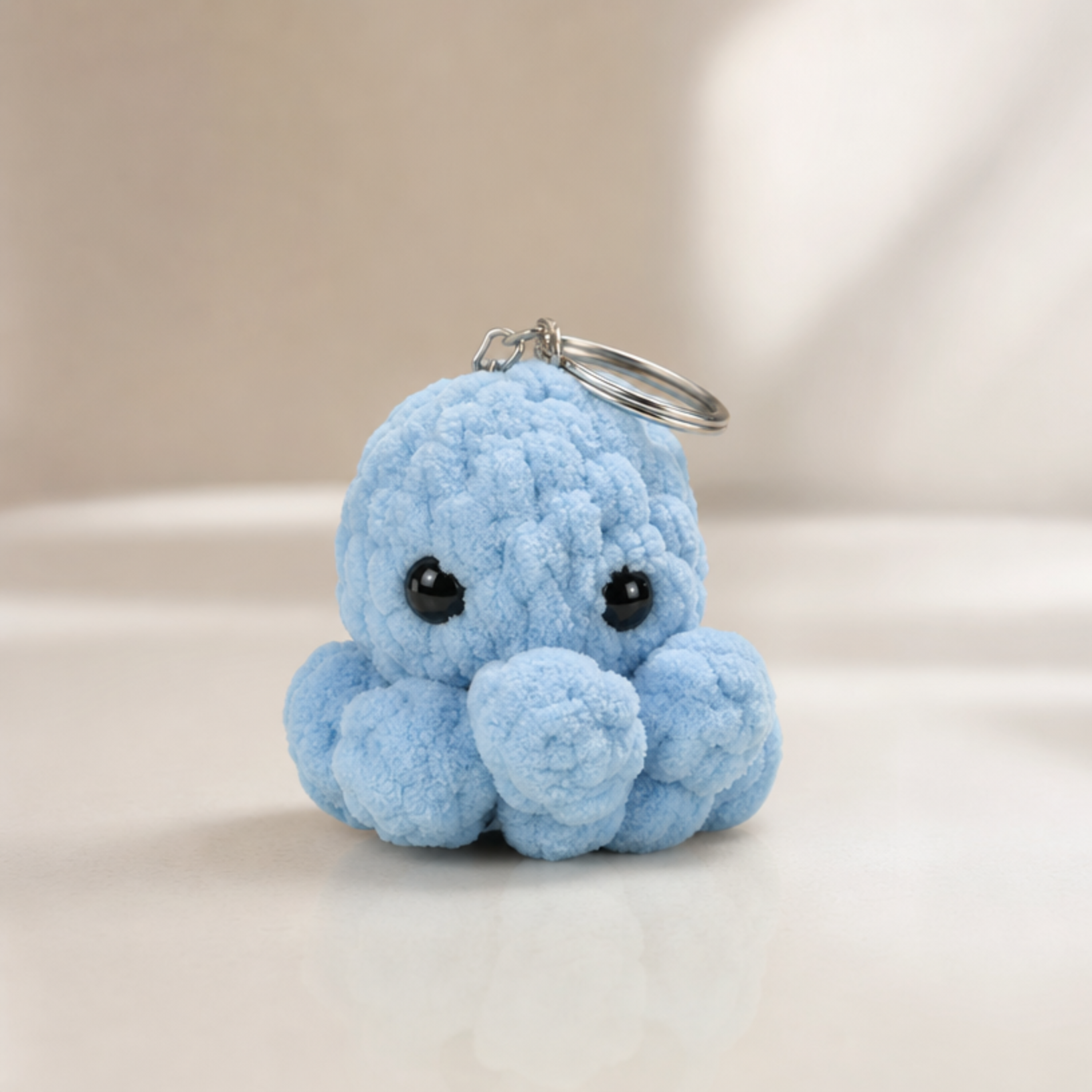 Crocheted octopus keychain in pastel peach